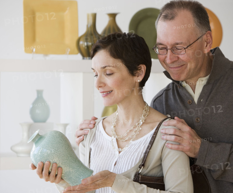 Couple looking at pottery in store.