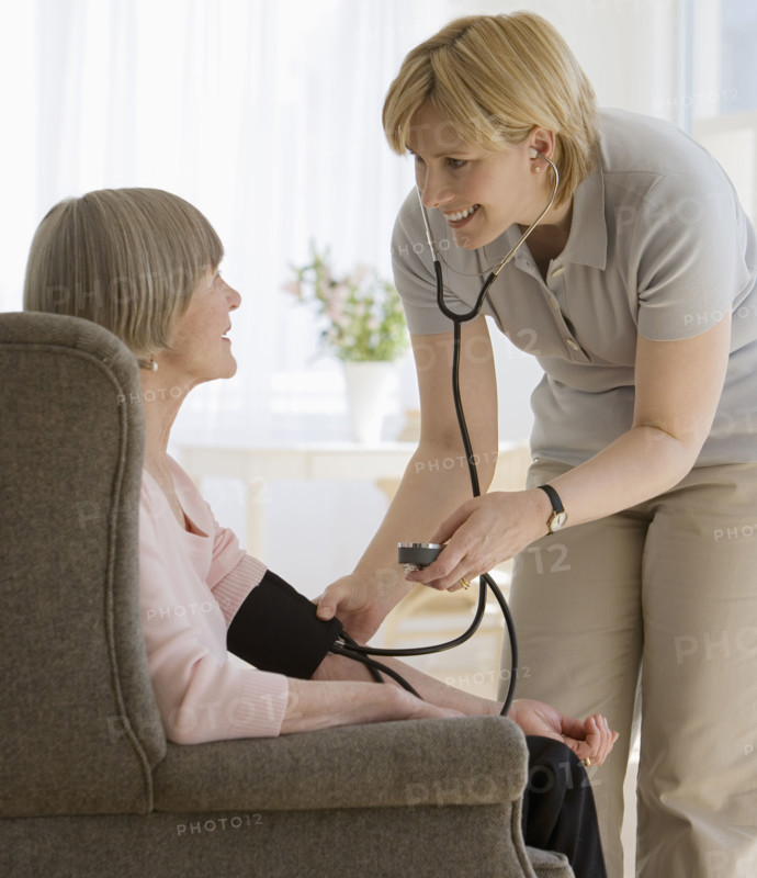 Senior woman having blood pressure taken.