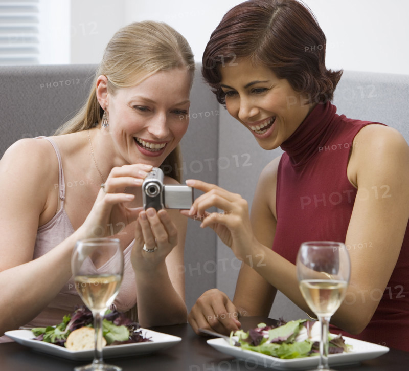 Two women looking at video camera.