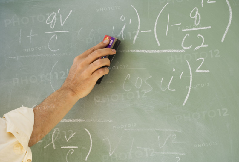 Professor erasing formulae on blackboard.