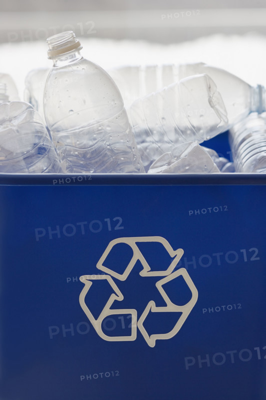 Recycle bin filled with bottles.