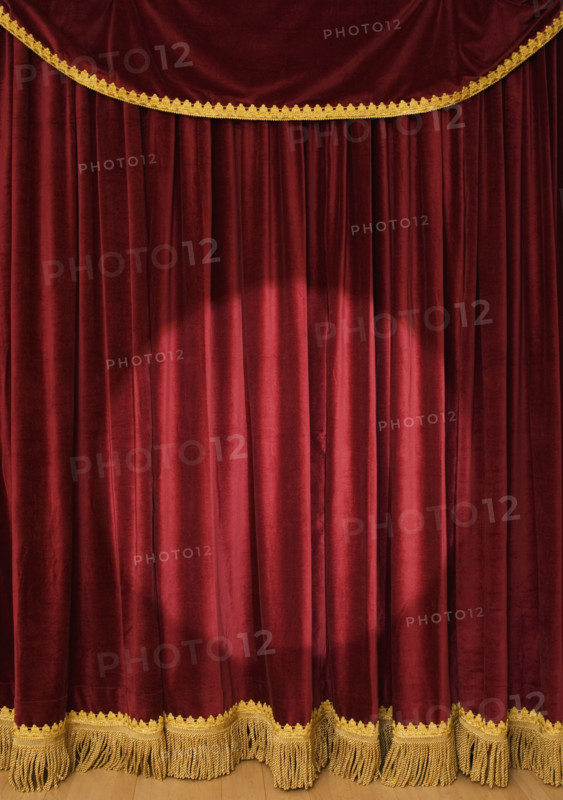 Spotlight on stage curtain.
