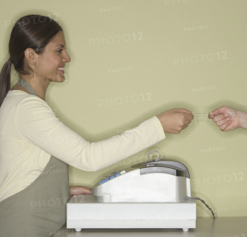 Indian female clerk accepting credit card.