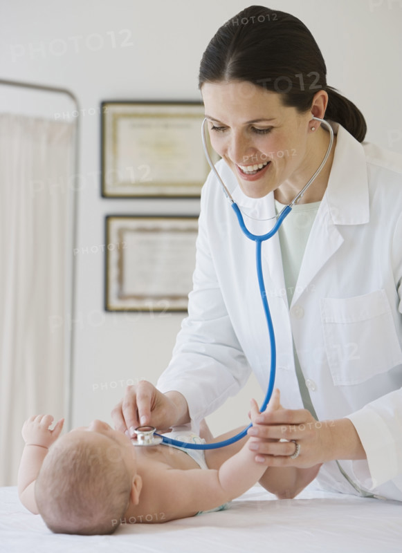 Female doctor examining baby.