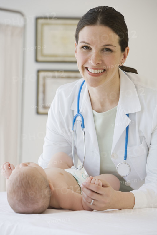 Female doctor examining baby.