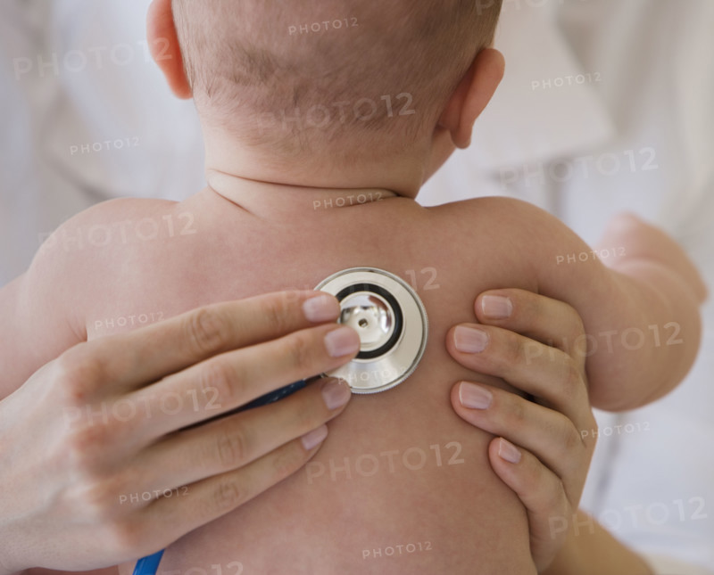 Doctor listening to baby’s lungs.