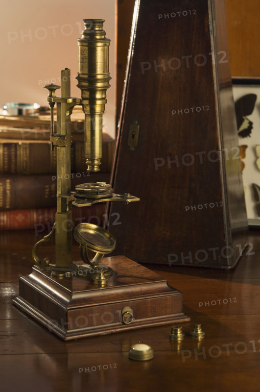 Old fashioned microscope on table.