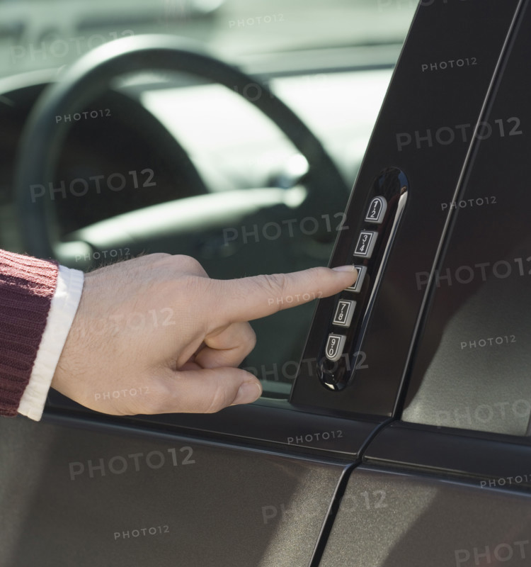 Man unlocking car door with keypad.