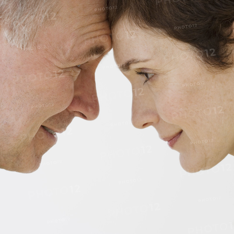 Close up of couple touching foreheads.