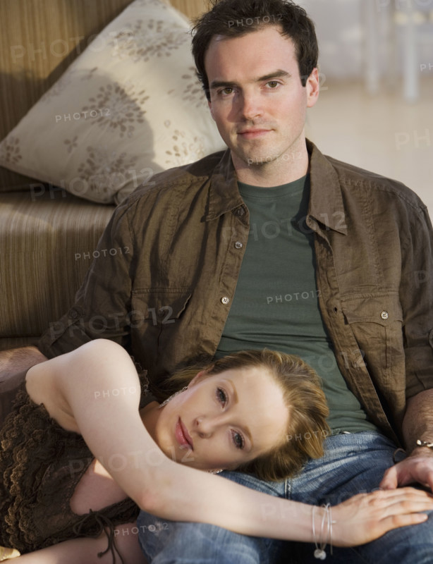 Woman laying head on boyfriend’s lap.