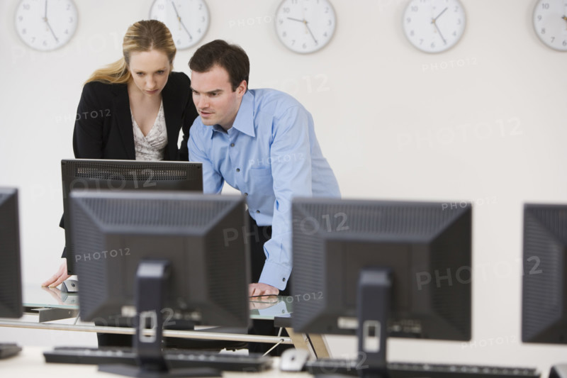 Businesspeople looking at computer.