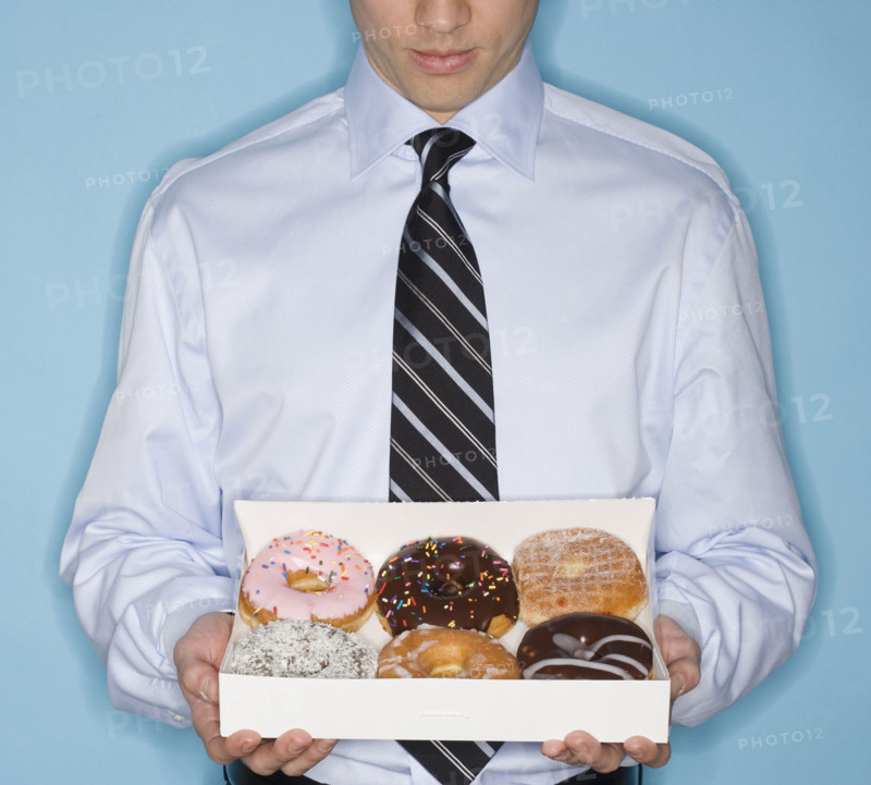 Businessman holding box of donut.