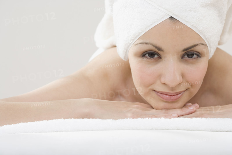 Portrait of woman laying on spa table.
