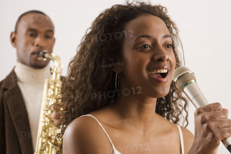 Woman singing into microphone.