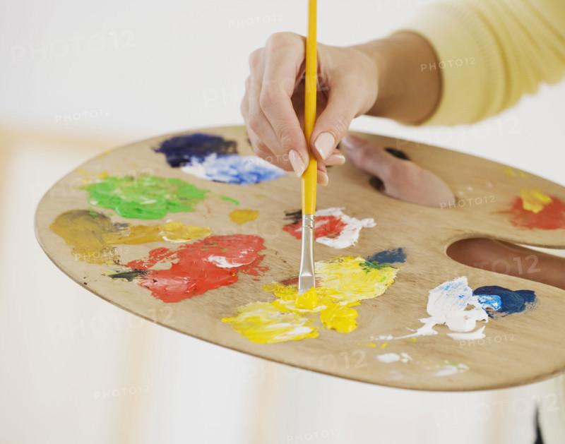 Close up of female artist using palette.