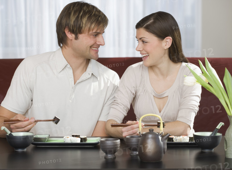 Couple smiling at each other at Japanese restaurant.