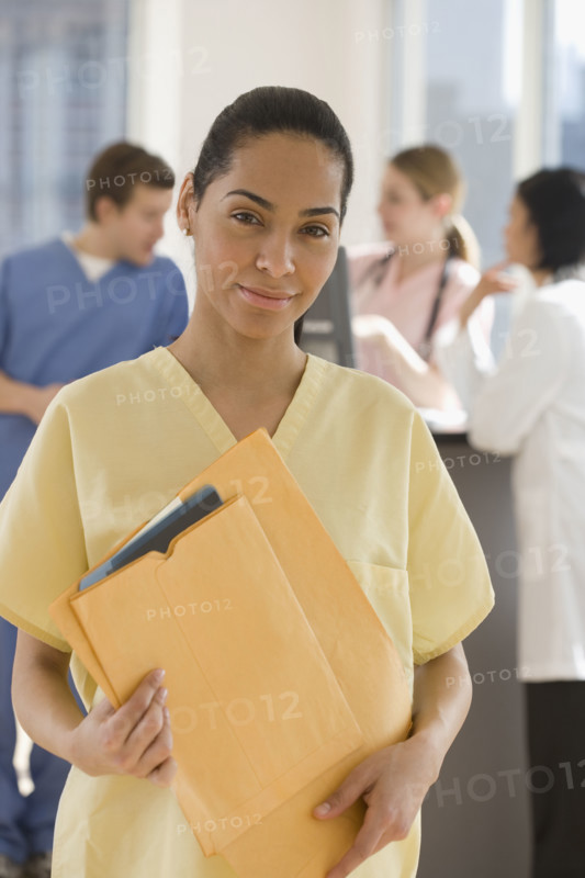 Portrait of female doctor holding files.