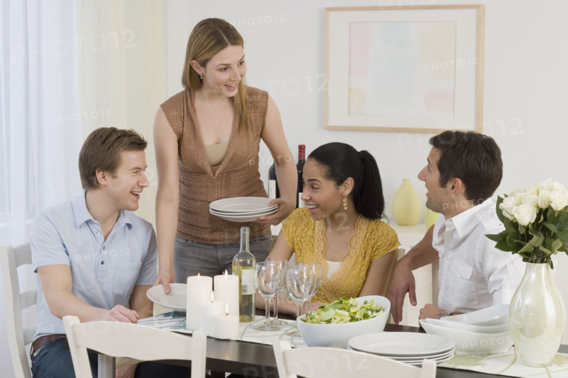 Two couples having dinner party.