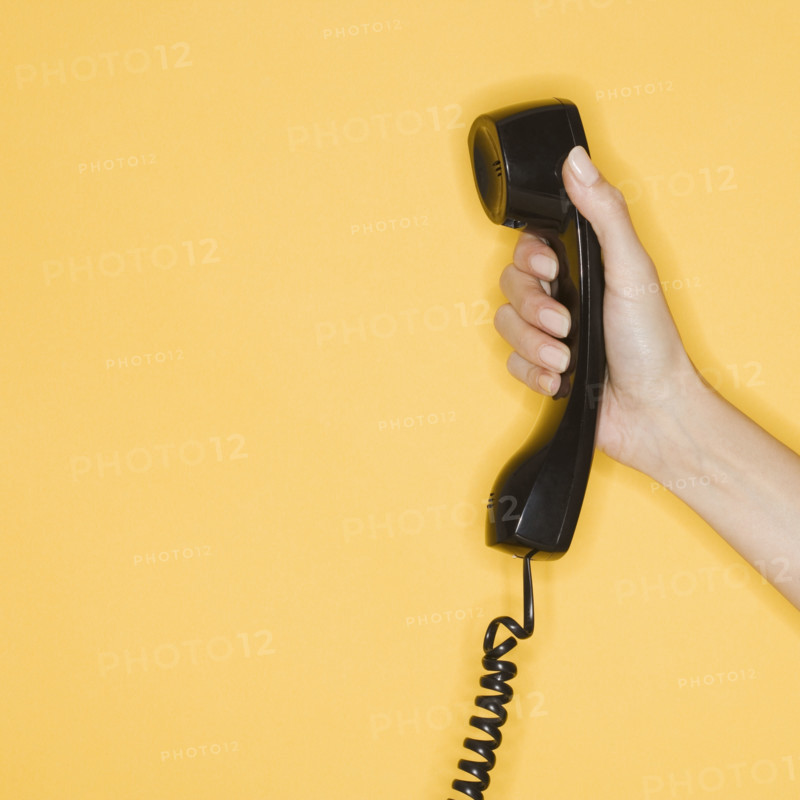 Woman holding telephone receiver.