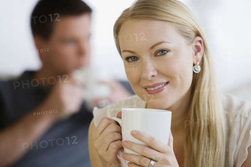 Woman holding coffee mug.