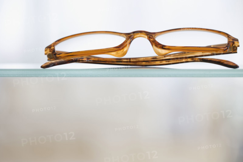 Close up of eye glasses on shelf.