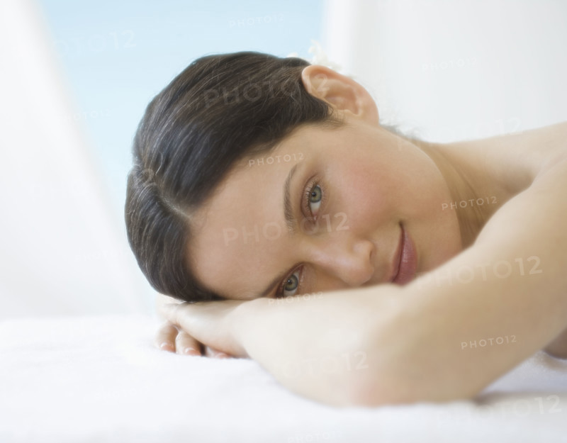 Woman laying on spa table.