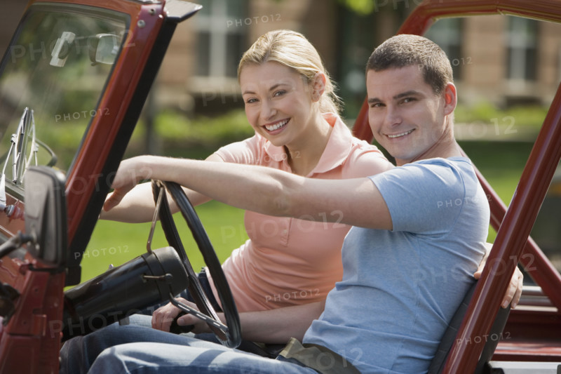 Couple sitting in jeep.