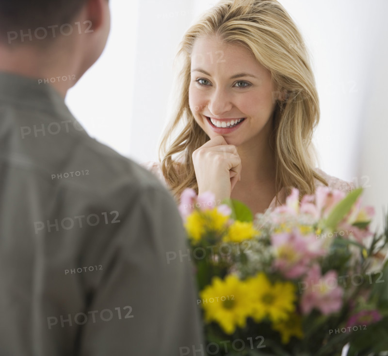Woman receiving flowers from boyfriend.