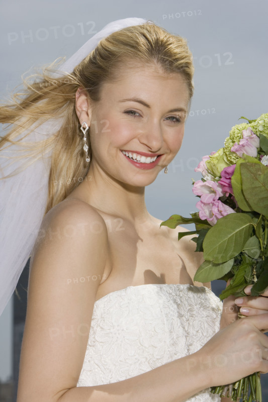 Bride holding bouquet of flowers.
