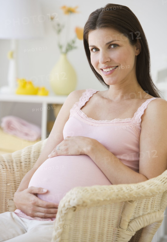 Pregnant woman with hands on belly.