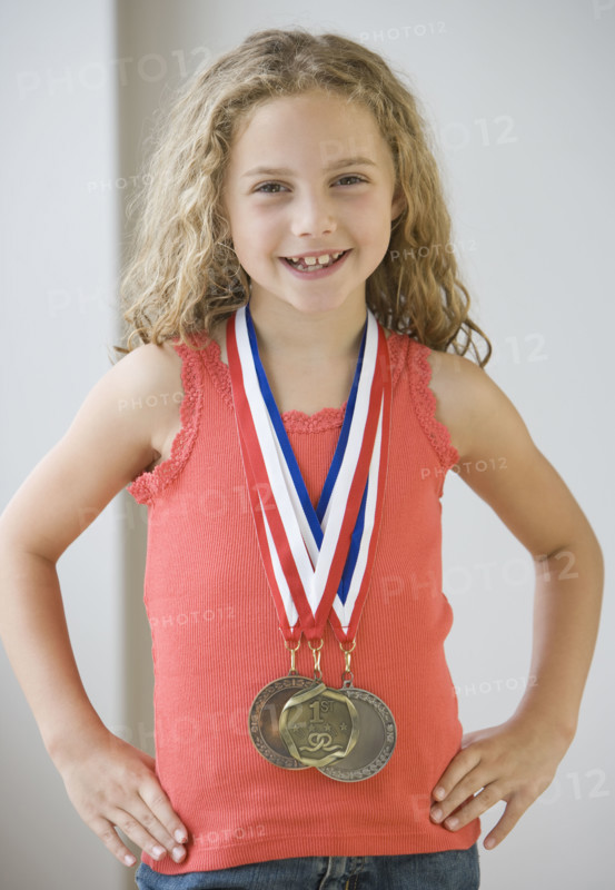 Girl wearing medals around neck.