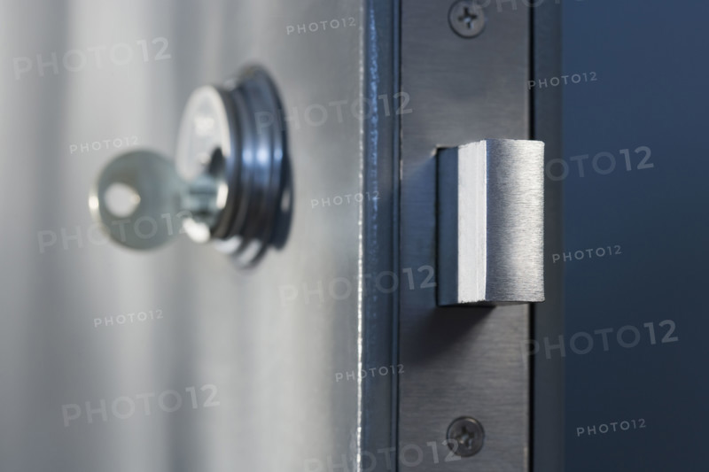 Close up of key in door lock.