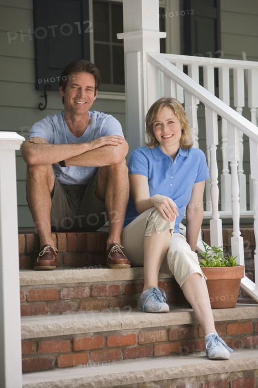 Couple sitting on porch steps.