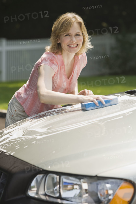 Woman washing car.