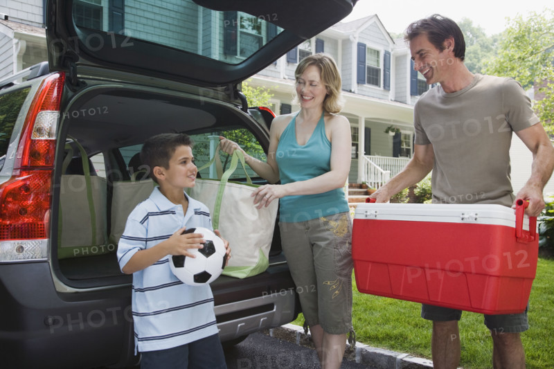 Family loading car for picnic.
