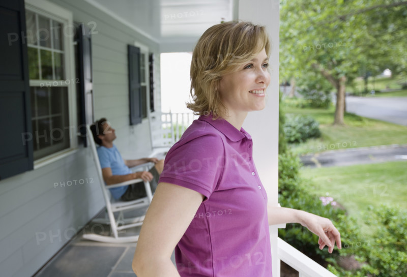 Couple relaxing on porch.