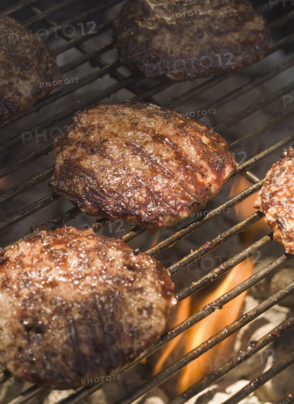 Hamburgers cooking on grill.