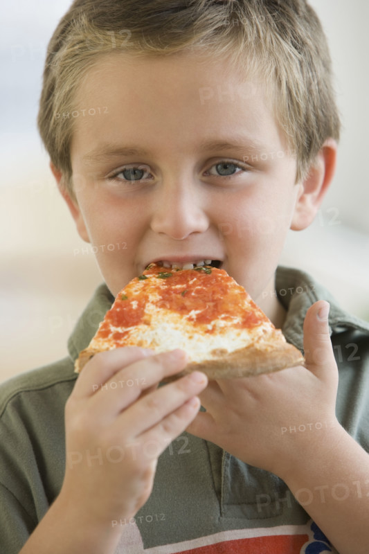 Boy eating pizza.