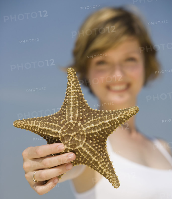 Woman holding starfish.
