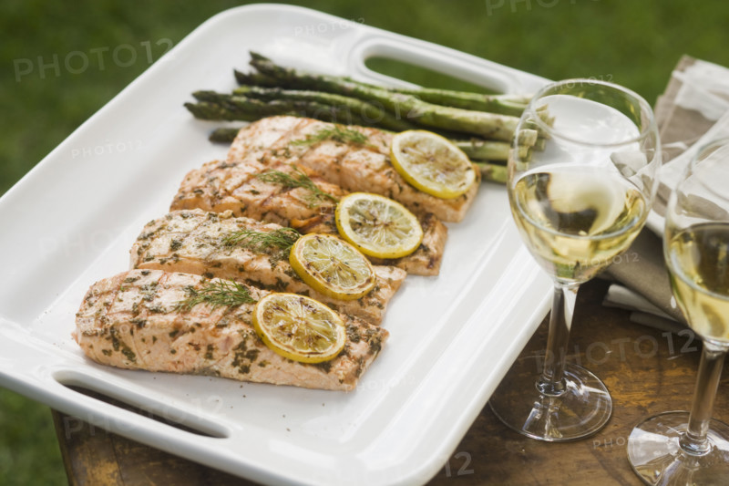 Grilled fish and asparagus on platter.