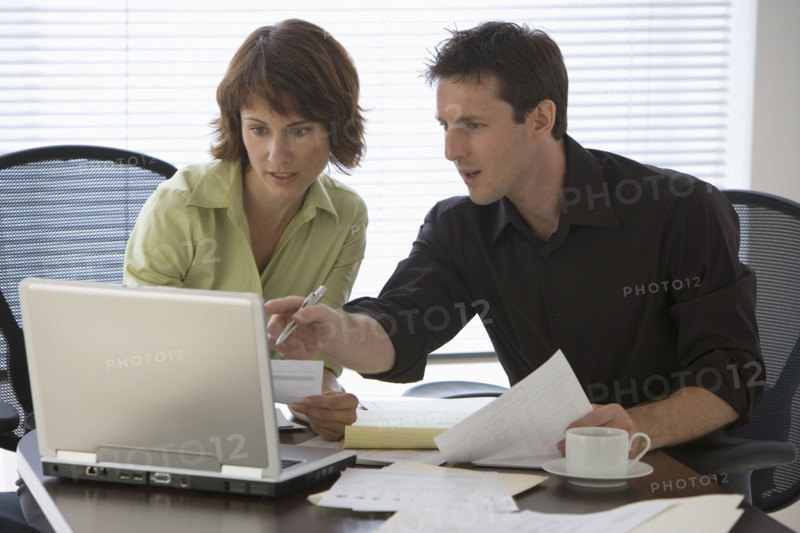 Couple paying bills online.