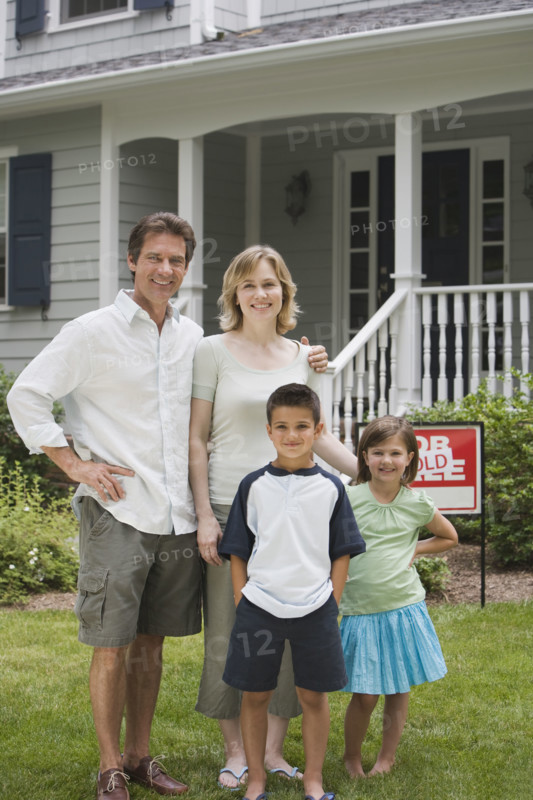 Family in front of new house.