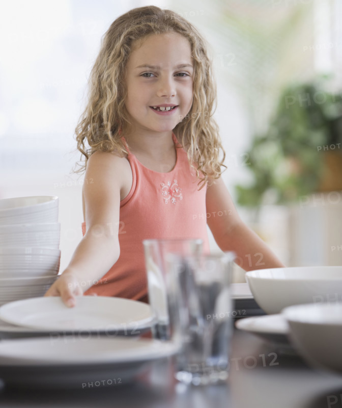 Girl setting table.