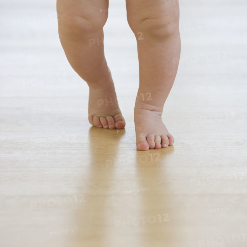 Close up of baby’s feet walking.