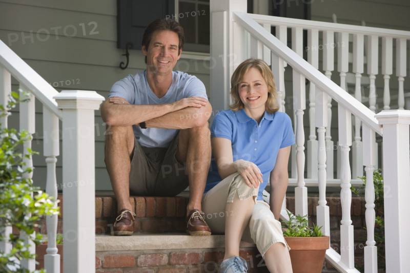 Couple sitting on porch steps.