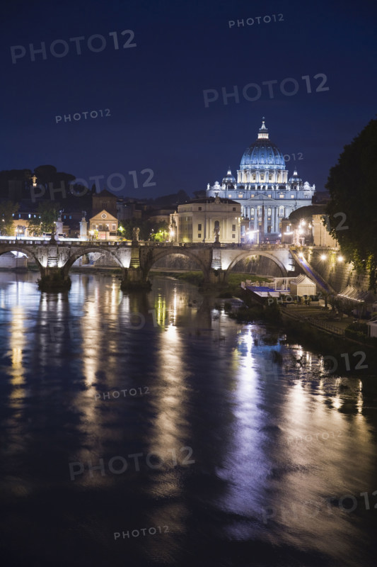 The Tiber River with St. Peter’s Basilica at night, Italy .