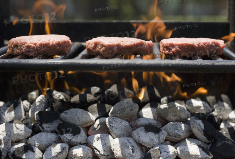 Hamburgers cooking on grill.