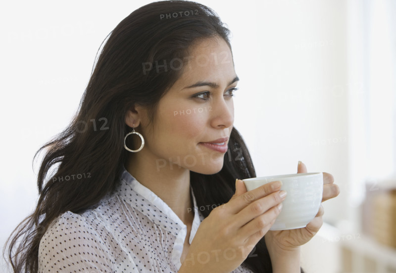 Woman drinking coffee.