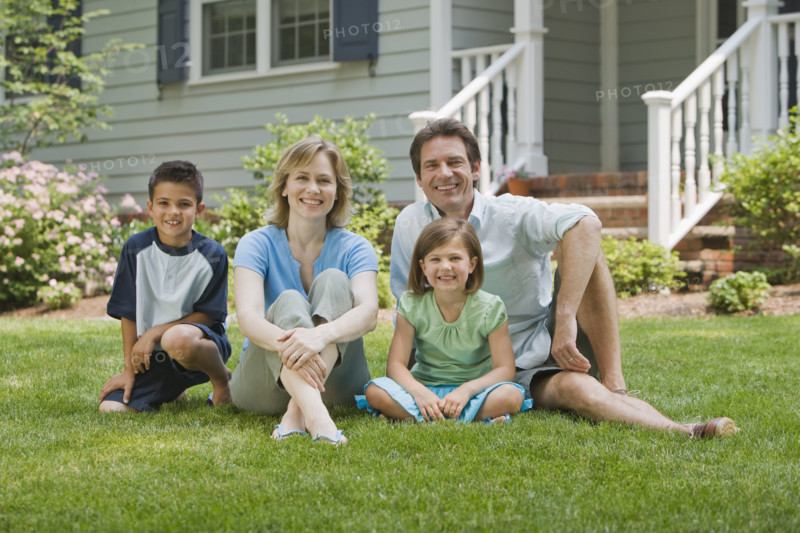 Family sitting on lawn.