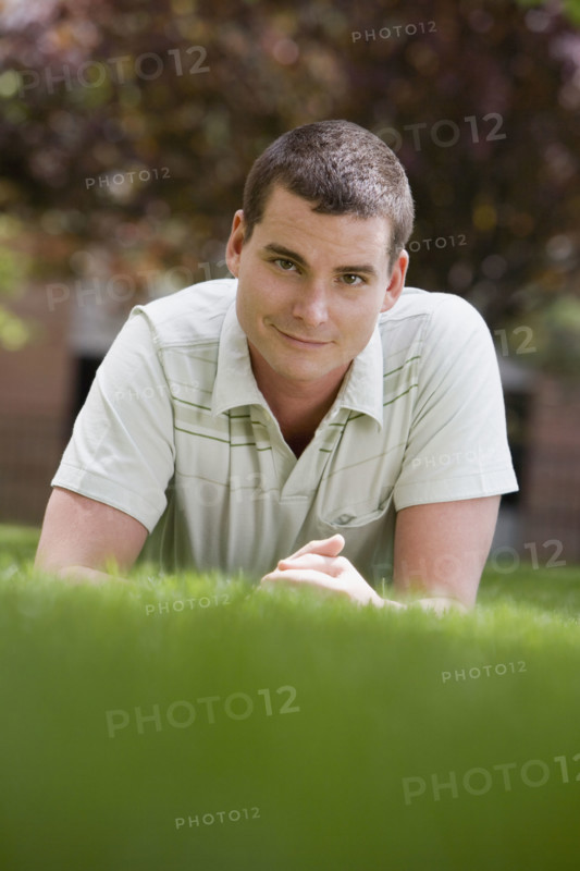 Man laying in grass.